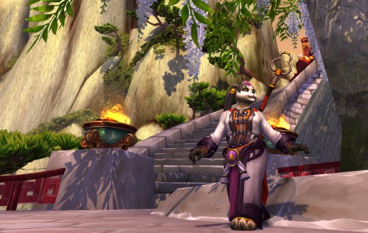 A pandaren lady mage stands under a canopy of leaves.
